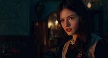 Movie still from “The Nutcracker and the Four Realms” (2018), directed by Joe Johnston – A young woman with long hair and a white collar; Close Up shot, Over the shoulder angle