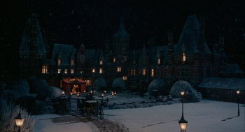 Movie still from “The Nutcracker and the Four Realms” (2018), directed by Joe Johnston – A night time scene of a town square with lights; Extreme Wide shot, High angle