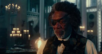 Movie still from “The Nutcracker and the Four Realms” (2018), directed by Joe Johnston – An older man wearing a bow tie and a vest; Close Up shot, Over the shoulder angle