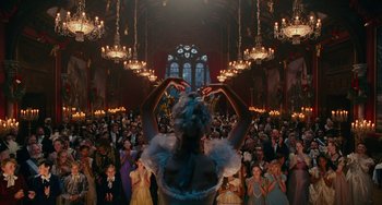 Movie still from “The Nutcracker and the Four Realms” (2018), directed by Joe Johnston – A crowd of people are gathered in a large room; Wide shot, Low angle
