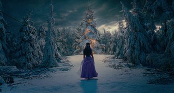 Movie still from “The Nutcracker and the Four Realms” (2018), directed by Joe Johnston – A woman in a purple dress in a snowy forest; Extreme Wide shot, High angle