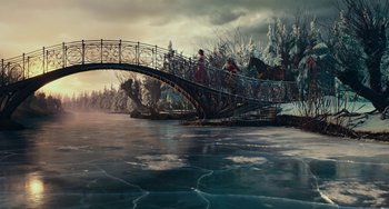 Movie still from “The Nutcracker and the Four Realms” (2018), directed by Joe Johnston – Two people on a bridge over a body of water; Extreme Wide shot, High angle