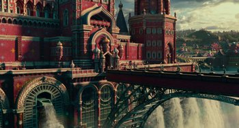Movie still from “The Nutcracker and the Four Realms” (2018), directed by Joe Johnston – An image of an old castle with a bridge in the background; Extreme Wide shot, Low angle