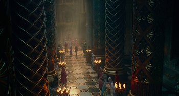 Movie still from “The Nutcracker and the Four Realms” (2018), directed by Joe Johnston – A group of people standing in a room with candles; Extreme Wide shot, High angle