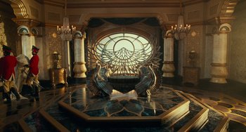 Movie still from “The Nutcracker and the Four Realms” (2018), directed by Joe Johnston – A room filled with a large window and a large statue of a bird; Extreme Wide shot, High angle