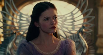 Movie still from “The Nutcracker and the Four Realms” (2018), directed by Joe Johnston – A woman in a purple dress looking to her left; Close Up shot, Low angle