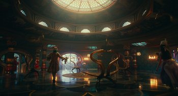 Movie still from “The Nutcracker and the Four Realms” (2018), directed by Joe Johnston – A man standing in front of a room filled with sculptures; Extreme Wide shot, Low angle