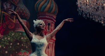 Movie still from “The Nutcracker and the Four Realms” (2018), directed by Joe Johnston – A woman in a white dress is performing a dance; Medium shot, Low angle