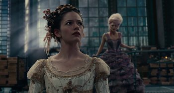 Movie still from “The Nutcracker and the Four Realms” (2018), directed by Joe Johnston – A woman in a white and gold dress and a woman in a purple dress; Medium shot, Over the shoulder angle