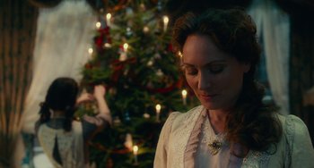 Movie still from “The Nutcracker and the Four Realms” (2018), directed by Joe Johnston – A woman standing in front of a christmas tree; Medium shot, Over the shoulder angle