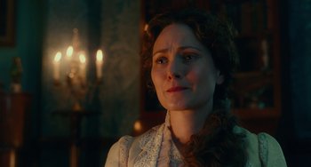 Movie still from “The Nutcracker and the Four Realms” (2018), directed by Joe Johnston – A woman in a white dress is looking to her left; Close Up shot, Over the shoulder angle