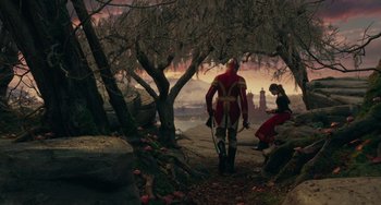 Movie still from “The Nutcracker and the Four Realms” (2018), directed by Joe Johnston – A man with a sword walking down a path next to trees; Extreme Wide shot, High angle