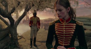 Movie still from “The Nutcracker and the Four Realms” (2018), directed by Joe Johnston – A man and a woman dressed in military uniforms; Medium shot, Over the shoulder angle