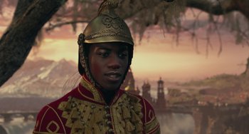 Movie still from “The Nutcracker and the Four Realms” (2018), directed by Joe Johnston – A man wearing a gold helmet and a red and gold uniform; Close Up shot, Over the shoulder angle