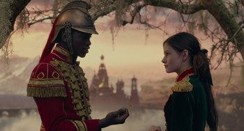 Movie still from “The Nutcracker and the Four Realms” (2018), directed by Joe Johnston – A man and a woman dressed in military uniforms; Medium shot, Over the shoulder angle