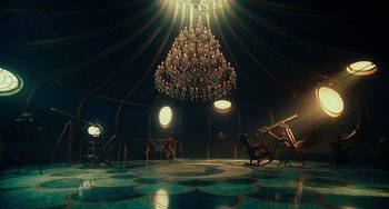 Movie still from “The Nutcracker and the Four Realms” (2018), directed by Joe Johnston – A chandelier hangs in the middle of a room; Extreme Wide shot, High angle