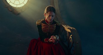 Movie still from “The Nutcracker and the Four Realms” (2018), directed by Joe Johnston – A woman in a red and black dress holding a box; Medium shot, High angle