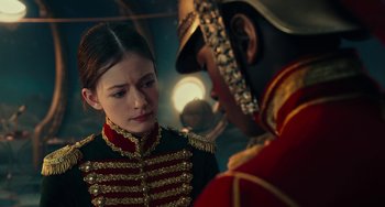 Movie still from “The Nutcracker and the Four Realms” (2018), directed by Joe Johnston – A man and a woman in military uniforms talking to each other; Close Up shot, Over the shoulder angle