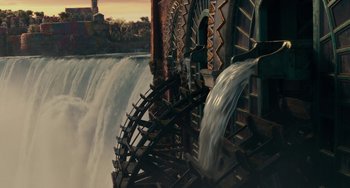 Movie still from “The Nutcracker and the Four Realms” (2018), directed by Joe Johnston – A water wheel with water coming out of it; Extreme Wide shot, High angle