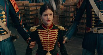 Movie still from “The Nutcracker and the Four Realms” (2018), directed by Joe Johnston – A woman in a military uniform holding a sword; Medium shot, Over the shoulder angle