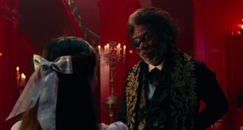 Movie still from “The Nutcracker and the Four Realms” (2018), directed by Joe Johnston – An older man wearing a suit and tie; Medium shot, Over the shoulder angle