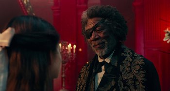 Movie still from “The Nutcracker and the Four Realms” (2018), directed by Joe Johnston – An older man wearing a suit and a tie talking to a young woman; Close Up shot, Over the shoulder angle