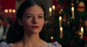 Movie still from “The Nutcracker and the Four Realms” (2018), directed by Joe Johnston – A beautiful young lady wearing a white dress; Close Up shot, Over the shoulder angle