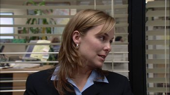 Movie still from “The Office” (2005), created by Ricky Gervais – A person wearing a suit and tie; Close Up shot, Over the shoulder angle