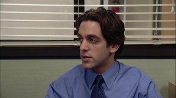 Movie still from “The Office” (2005), created by Ricky Gervais – A man wearing a blue dress shirt and a tie; Close Up shot, Over the shoulder angle