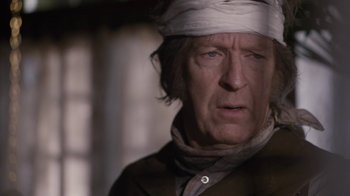 Movie still from “Anne with an E” (2017), created by Moira Walley-Beckett – An older man with a bandaged head; Close Up shot, Over the shoulder angle