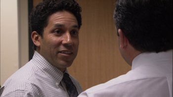 Movie still from “The Office” (2005), created by Ricky Gervais – A man in a tie talking to another man in a dress shirt; Close Up shot, Over the shoulder angle