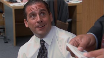 Movie still from “The Office” (2005), created by Ricky Gervais – A person wearing a shirt and tie; Medium shot, Over the shoulder angle