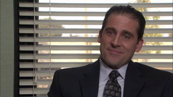 Movie still from “The Office” (2005), created by Ricky Gervais – A person wearing a suit and tie; Close Up shot, High angle