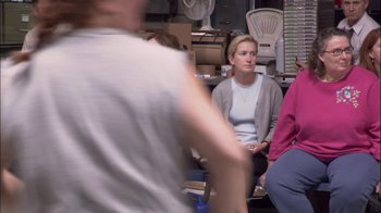 Movie still from “The Office” (2005), created by Ricky Gervais – A group of people sitting in a room; Medium shot, Over the shoulder angle