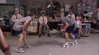 Movie still from “The Office” (2005), created by Ricky Gervais – A group of men playing a game of basketball; Wide shot, High angle