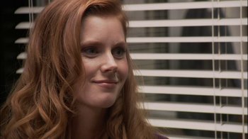 Movie still from “The Office” (2005), created by Ricky Gervais – A person with long red hair; Close Up shot, Over the shoulder angle