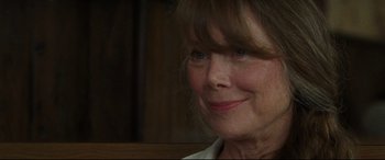 Movie still from “The Old Man & the Gun” (2018), directed by David Lowery – An older woman smiling at the camera; Close Up shot, Over the shoulder angle