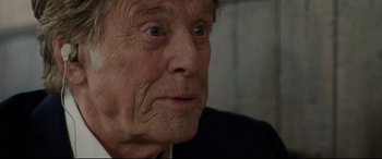 Movie still from “The Old Man & the Gun” (2018), directed by David Lowery – An old man with a wrinkled face looking into the distance; Close Up shot, Over the shoulder angle