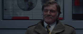 Movie still from “The Old Man & the Gun” (2018), directed by David Lowery – An older man wearing a jacket and tie; Close Up shot, Over the shoulder angle