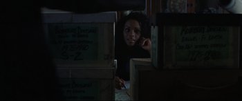 Movie still from “The Old Man & the Gun” (2018), directed by David Lowery – A woman sitting in front of a pile of boxes; Close Up shot, Over the shoulder angle