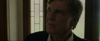 Movie still from “The Old Man & the Gun” (2018), directed by David Lowery – An older man with blue eyes looking into the distance; Close Up shot, Over the shoulder angle
