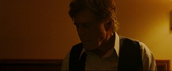 Movie still from “The Old Man & the Gun” (2018), directed by David Lowery – An older man wearing a white shirt and a vest; Close Up shot, Low angle