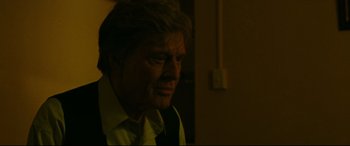 Movie still from “The Old Man & the Gun” (2018), directed by David Lowery – An older man wearing a yellow shirt and a tie; Close Up shot, Over the shoulder angle