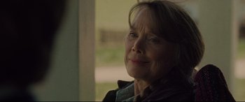 Movie still from “The Old Man & the Gun” (2018), directed by David Lowery – An older woman is looking out a window; Close Up shot, Over the shoulder angle