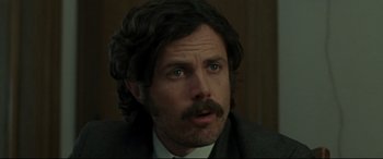 Movie still from “The Old Man & the Gun” (2018), directed by David Lowery – A person wearing a suit and tie; Close Up shot, Over the shoulder angle