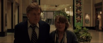 Movie still from “The Old Man & the Gun” (2018), directed by David Lowery – A man and a woman standing next to each other; Medium shot, Over the shoulder angle