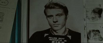 Movie still from “The Old Man & the Gun” (2018), directed by David Lowery – A black and white photo of a man in a police shirt; Close Up shot, Low angle