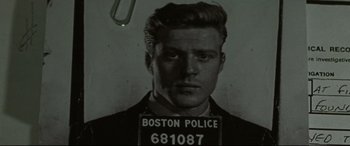 Movie still from “The Old Man & the Gun” (2018), directed by David Lowery – A black - and - white photo of a man in a boston police uniform; Close Up shot, Low angle