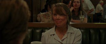 Movie still from “The Old Man & the Gun” (2018), directed by David Lowery – An older woman sitting at a table with a cup of coffee; Close Up shot, Over the shoulder angle