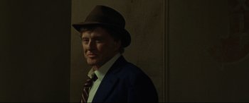 Movie still from “The Old Man & the Gun” (2018), directed by David Lowery – A man wearing a suit and a hat; Close Up shot, Over the shoulder angle